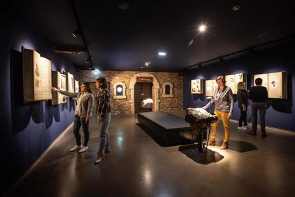 Dark interior of the museums with lighted displays on walls