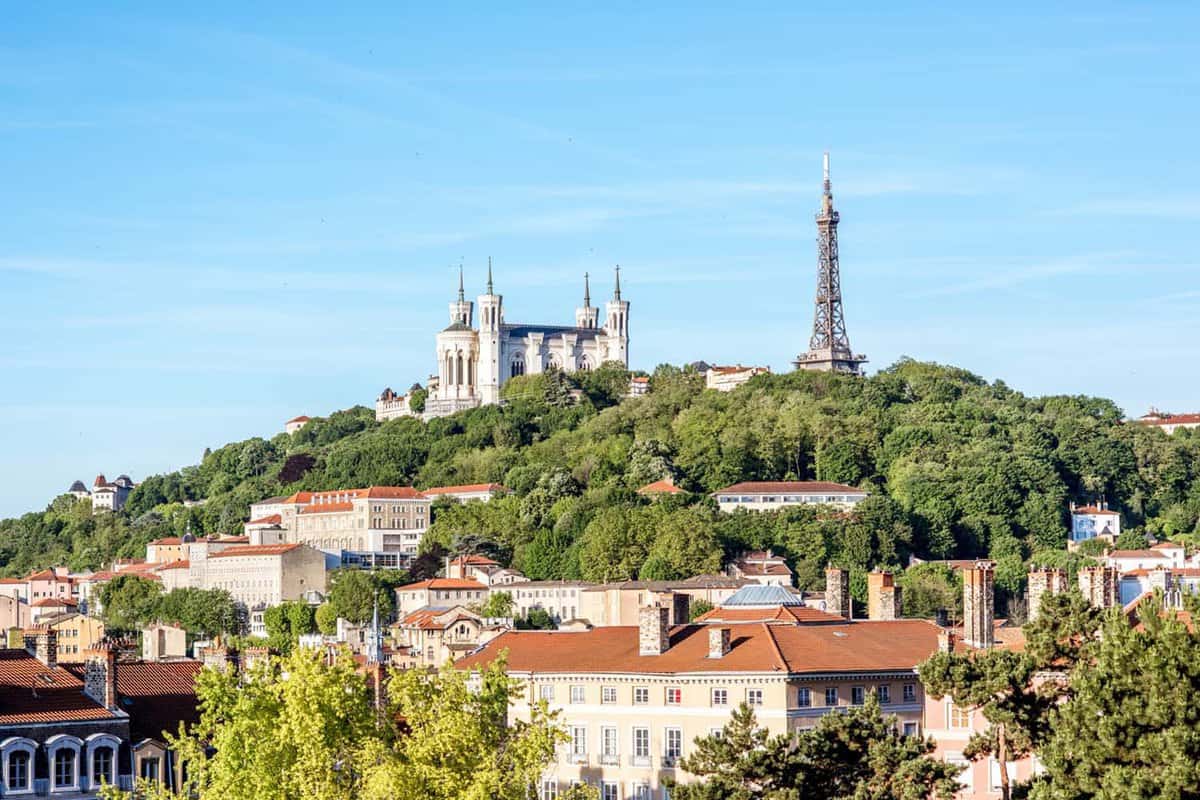View on the mountain with Notre-Dame cathedral and metallic tower in Lyon city in France