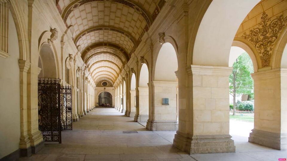 Courtyard with columns and arches in golden stone