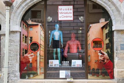 Museum of miniatures in french city Lyon. Glass showcase of the museum with action figures in