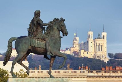 Man on horse statue in foreground, basilica behind