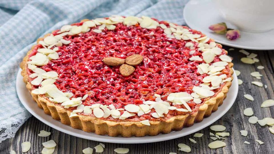 close up of a beautiful round tart with almonds on