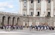 Guards on horseback move through Armory Square during the changing of the guard at the Royal Palace of Madrid.