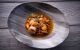 Modern tripe stew (Callos a la Madrilena) is displayed in a shallow bowl.