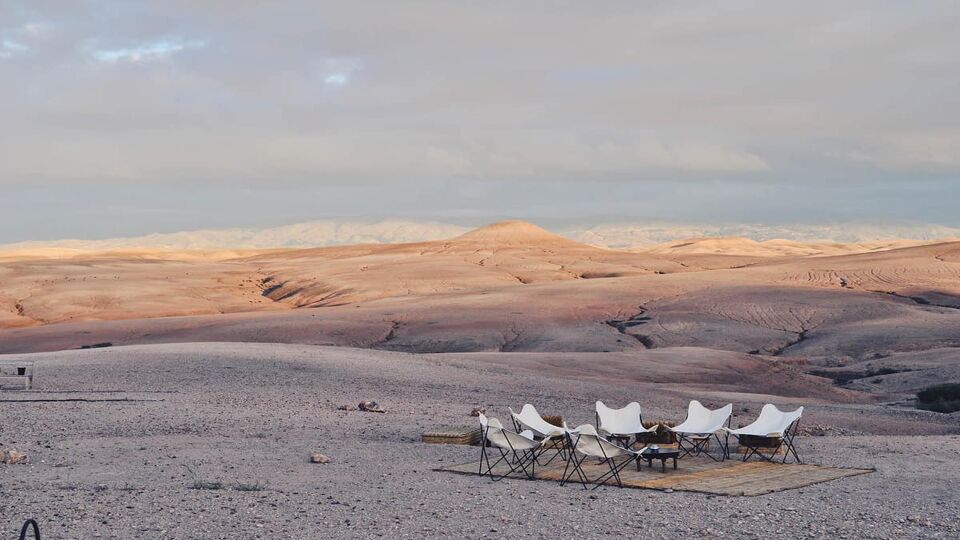 Chairs around a campfire in the desert
