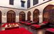 Red and black lounge chairs in interior courtyard of Turkish Bath