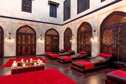 Red and black lounge chairs in interior courtyard of Turkish Bath