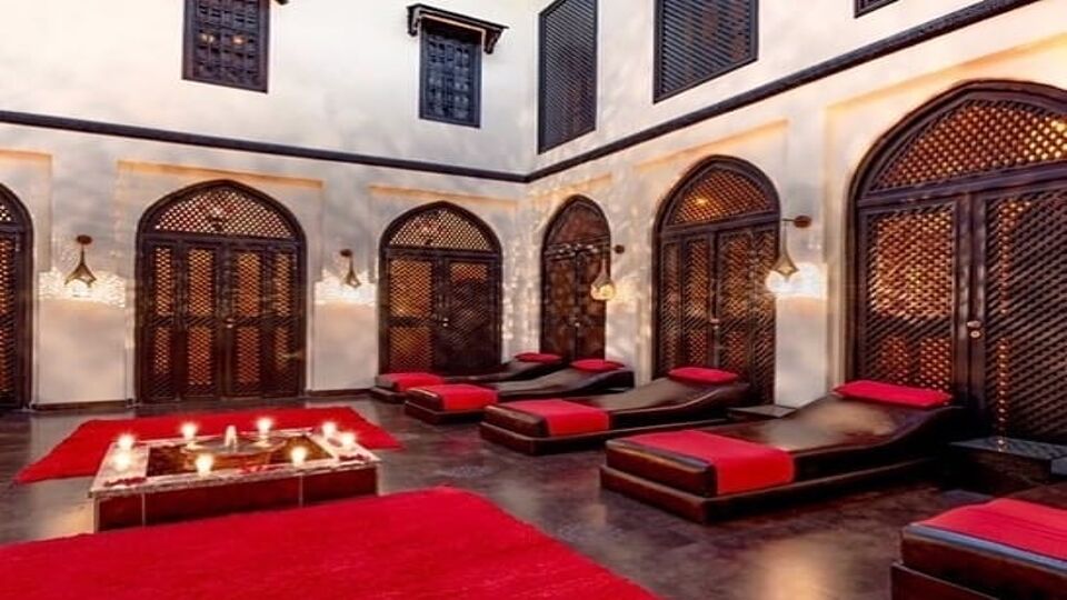 Red and black lounge chairs in interior courtyard of Turkish Bath
