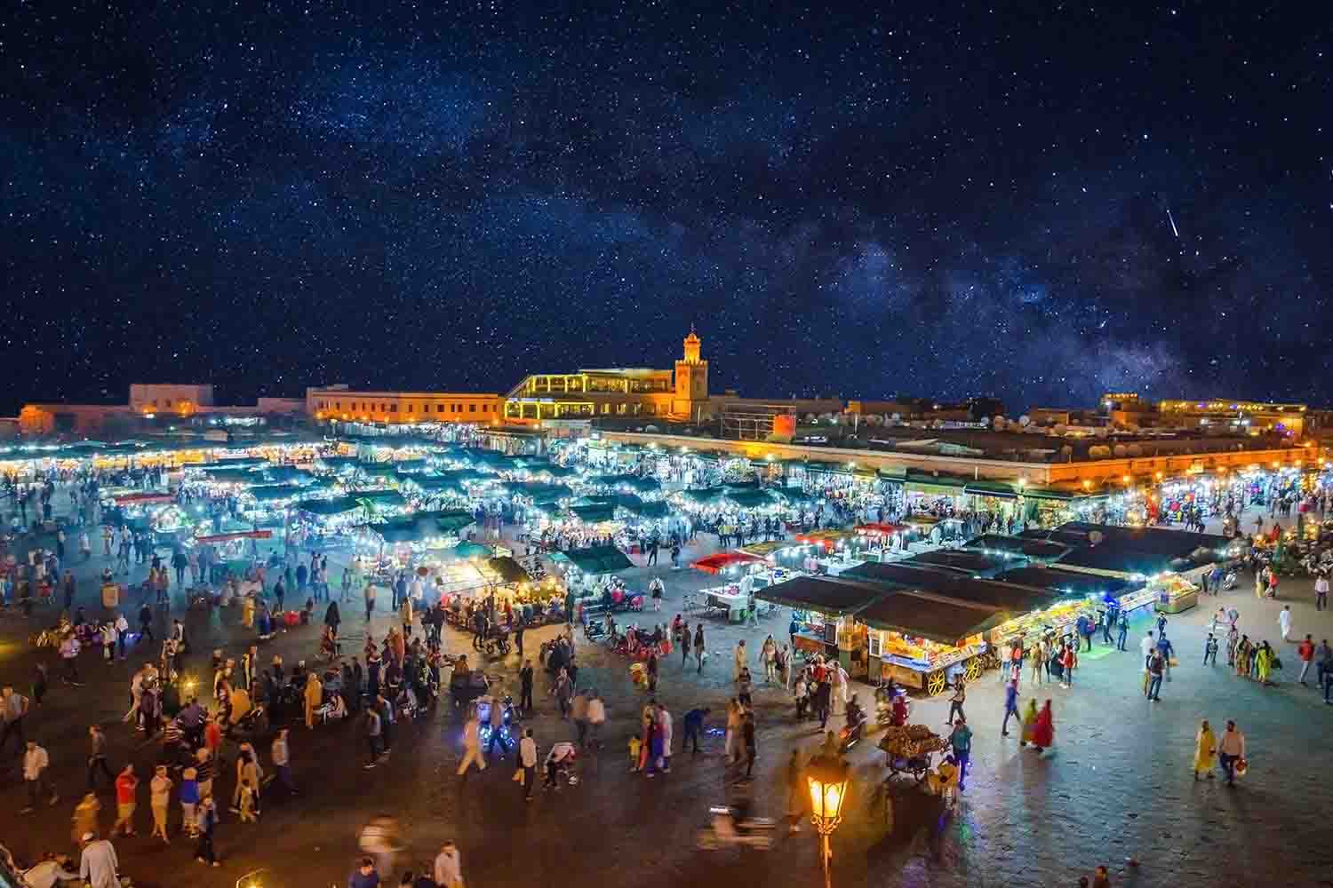 Night-time view of bustling marketplace full of food vendors