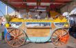 Juice vendor in an ornate, wheeled cart