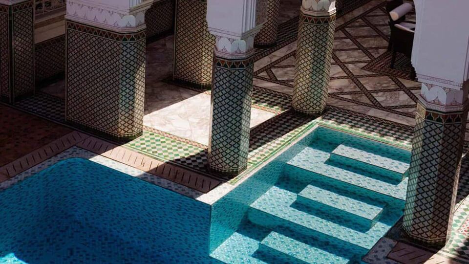 Blue-tiled steps leading down into indoor pool