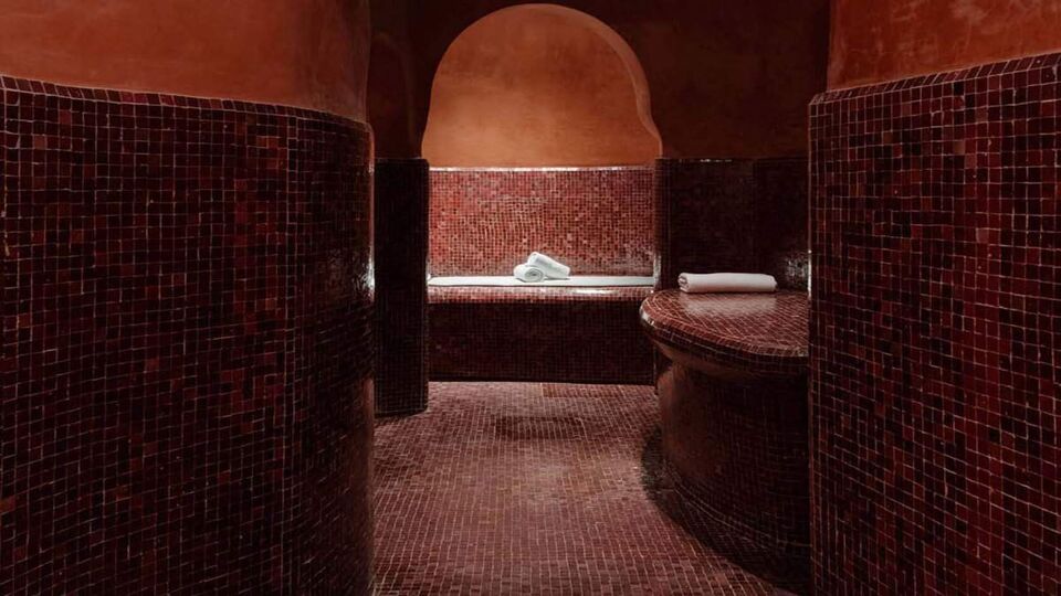 Dimly-lit, tiled interior of a Turkish Bath