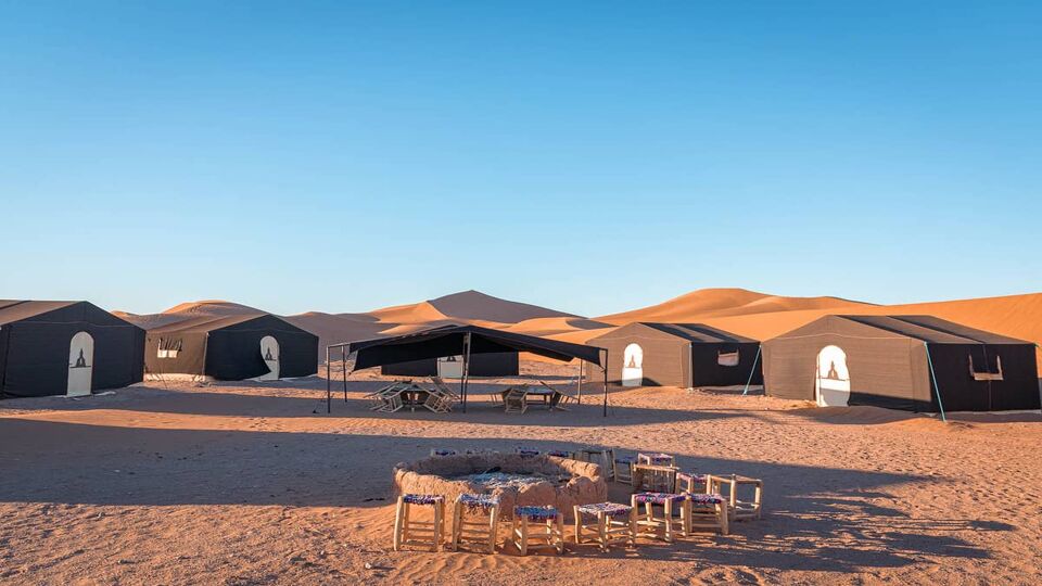 Campground and fire pit on sand dune in the Sahara desert