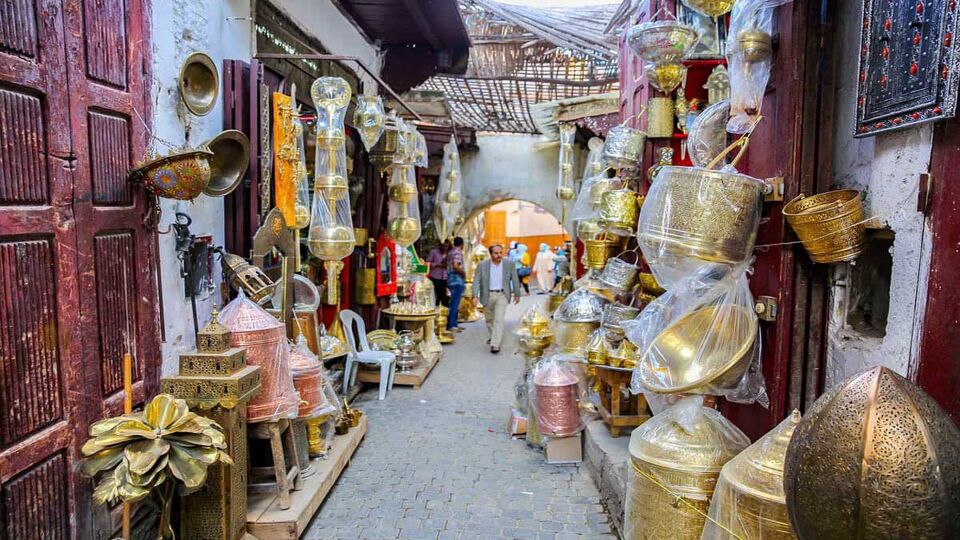 Passageway in a souk lined with stores and lanterns for sale