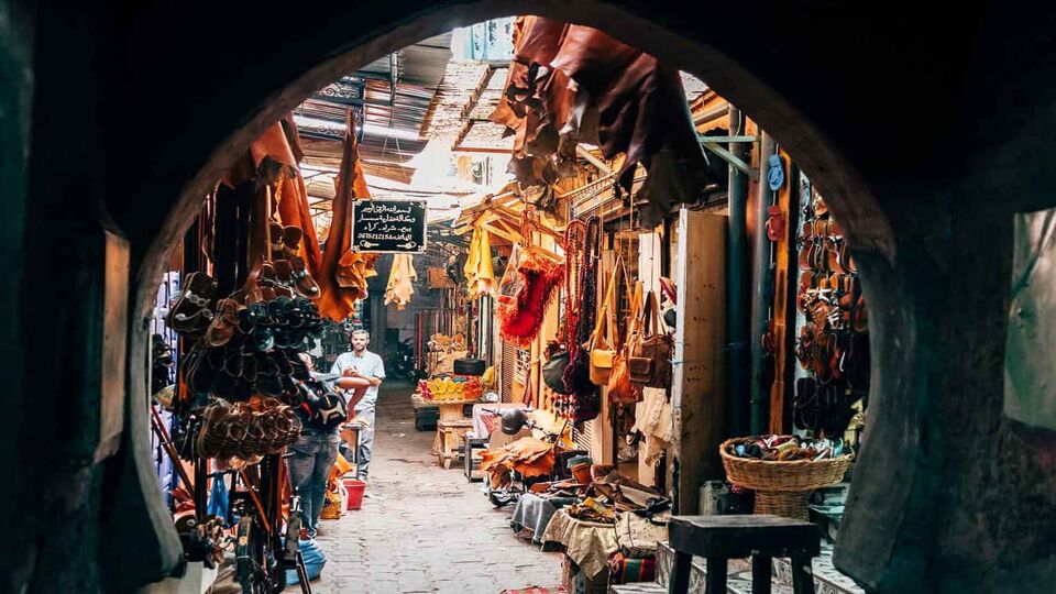 View of several colourful stalls through an archway