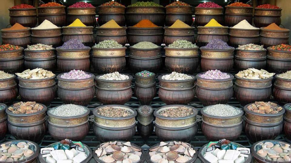 Buckets of spices and other dried goods in front of a store