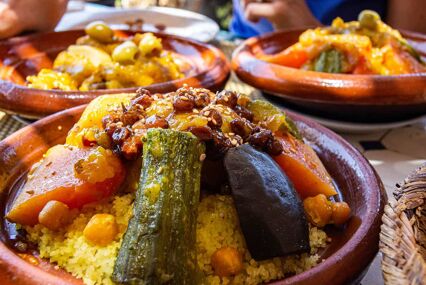 Close-up of vegetables on cous-cous served in a clay tagine