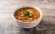 Bowl of harira (chickpea) soup on a wooden table