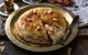 Moroccan pie (pastilla) on a metal dish