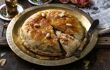 Moroccan pie (pastilla) on a metal dish