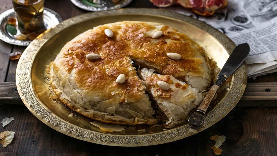 Moroccan pie (pastilla) on a metal dish