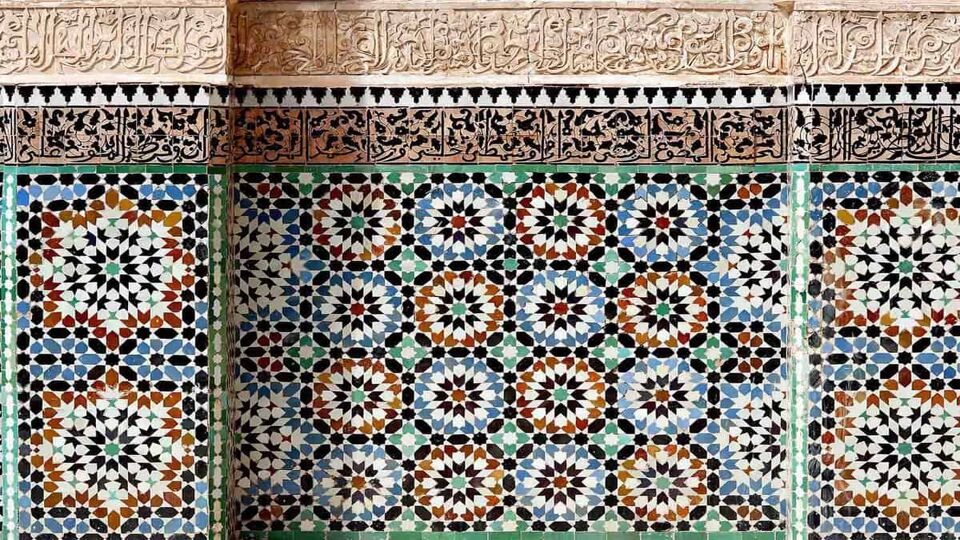 Islamic calligraphy and colorful geometric patterns adorn the walls of the Ben Youssef mosque in the central medina area of Marrakech