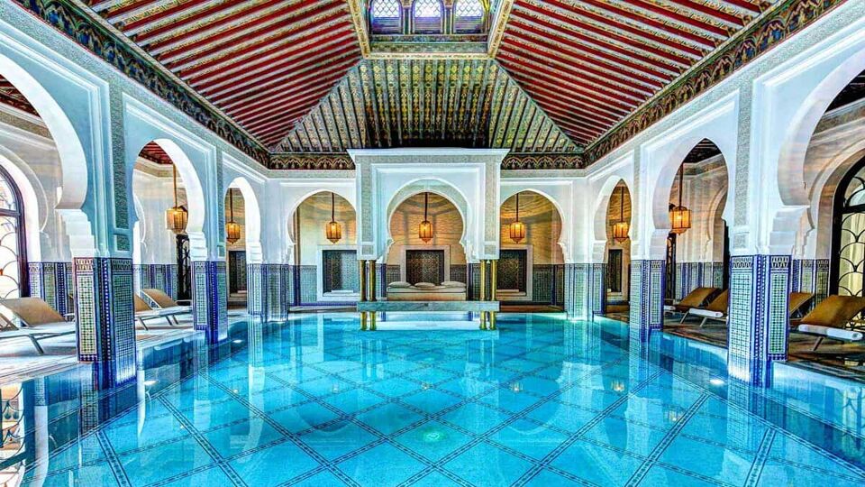interior of a stunning vaulted room with big blue swimming pool