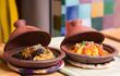 two tajine dishes filled with food