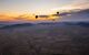 Hot-air balloons flying over the Moroccan desert at sunset