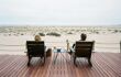 A couple on deck chairs looking out at the Skeleton Coast