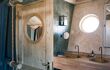 A double bathroom and wooden shower inside a lodge