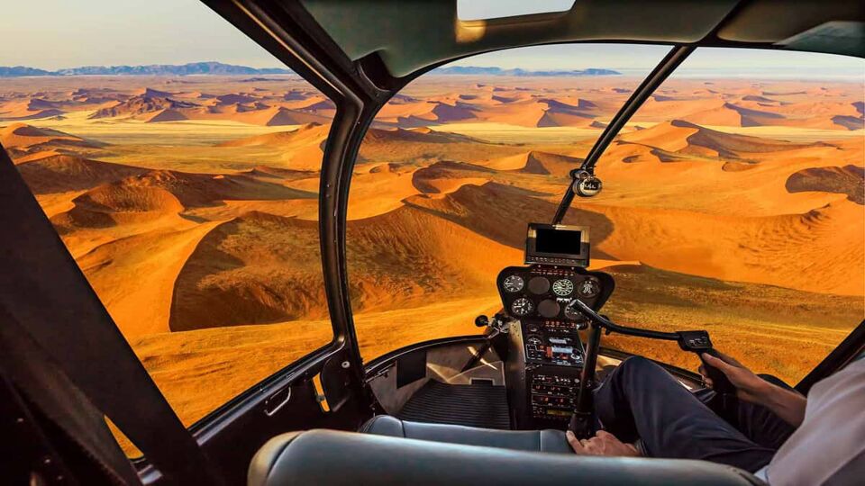 view of the dunes from within the helicopter cockpit