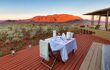 a romantic table for two on the orange decking looking out to the desert