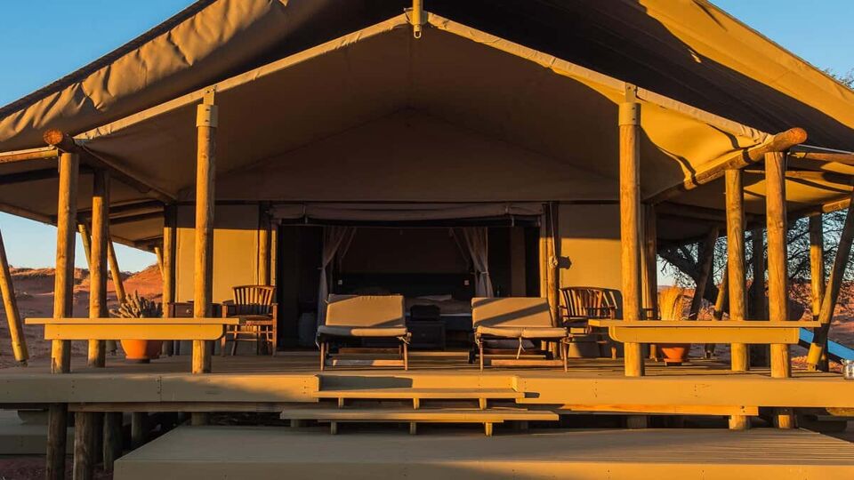 a large safari tent in golden sunlight