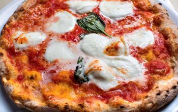 Close up of a traditional Neapolitan pizza with basil and mozarella