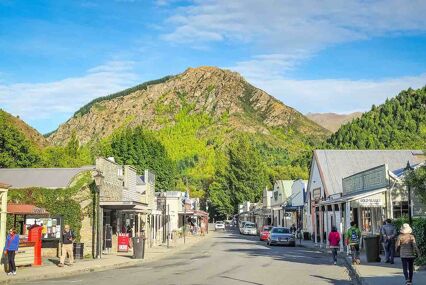 Tourists are walking around the main street of Arrowtown