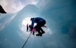 An unidentified tourist hikes through a hold at fox glacier, New Zealand. This glacier is one of the most famous attraction among tourist, traveler in New Zealand.