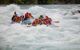 Close up of inflatable raft with 6 passengers on white water