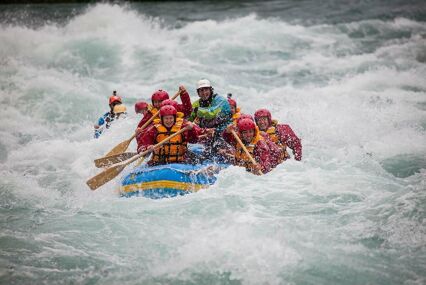 Close up of inflatable raft with 6 passengers on white water