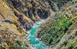 Aerial view of a beautiful azure river cutting through a canyon