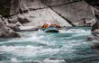 Inflatable raft on a fairly flat whitewater river in Queenstown