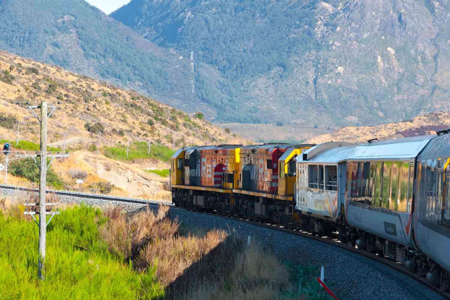 Arthur's Pass National Park, New Zealand, KiwiRail TranzAlpine scenic train, riding among beautiful plains and mountains, popular tourist transportation on South Island