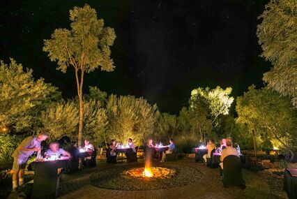 People dining outside at sunset for the 'Under a Desert Moon' dining experience