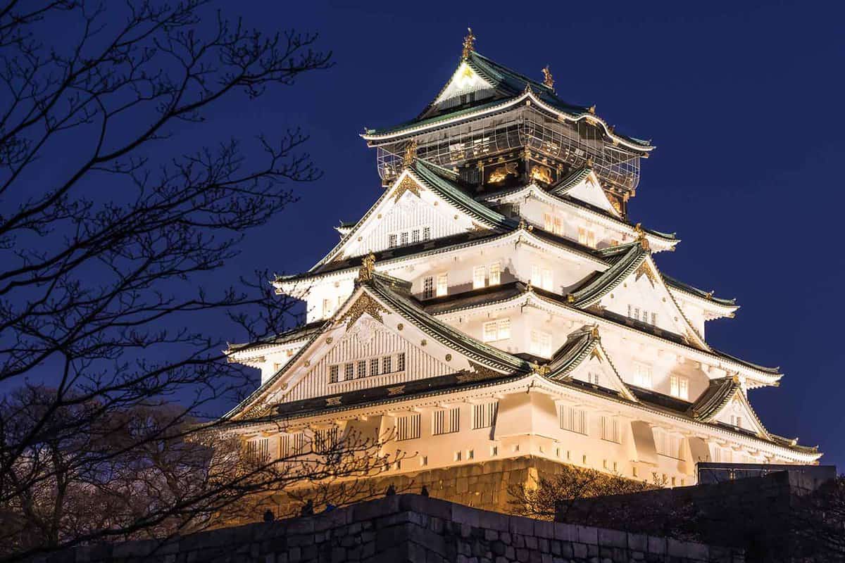 Exterior of Osaka Castle at night, all lit up