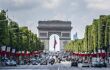 Landscape view of the road to the Arc de Triomphe with flags surrounding road