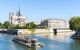 Packed tourist boat on river in front of Notre Dame