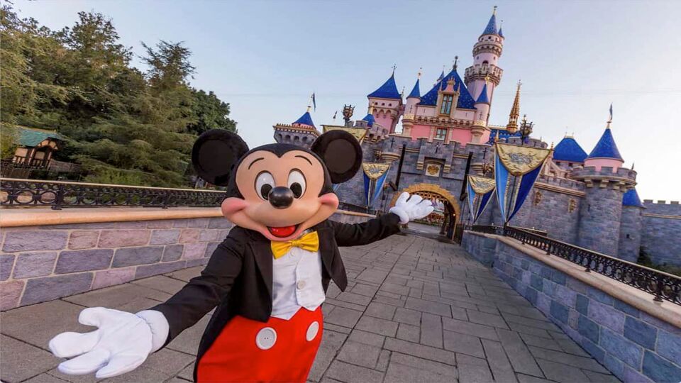 Landscape view of Mickey the Mouse posing in front of Disneyland Paris