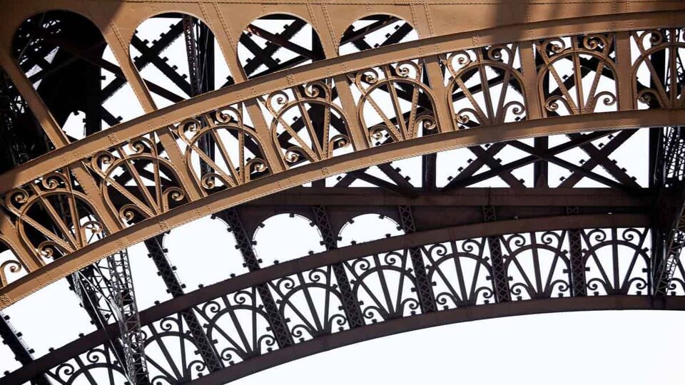 Close up shot of the detailed metal structure of the Eiffel Tower