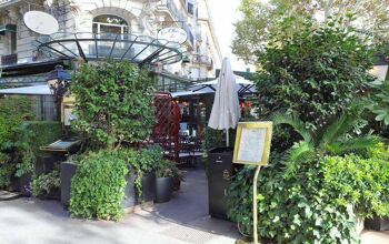 The entrance to cafe La Closerie des Lilas, where there are plants covering perimeter