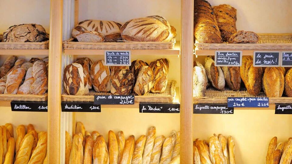 Selection of breads on shelves in a bakery